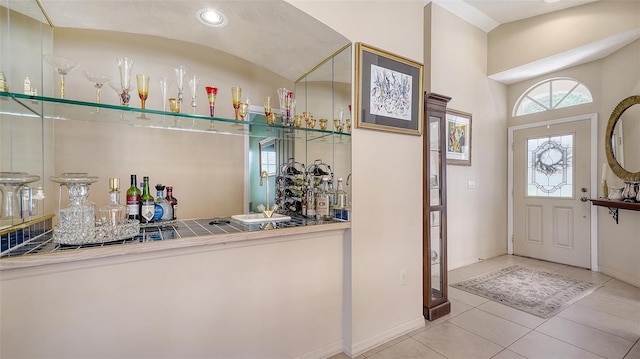 3984 Lyndhurst Ct, Sarasota, FL 34235 - foyer with tile patterned floors, baseboards, and indoor bar