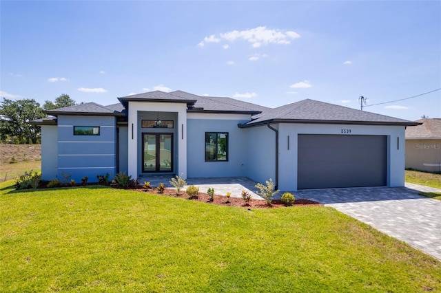 2539 SW 4th Ave, Cape Coral, FL 33914 - prairie-style home with stucco siding, an attached garage, decorative driveway, and a front lawn
