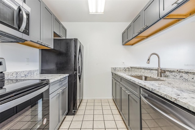 3781 59th Ave W Unit 3781, Bradenton, FL 34210 - kitchen featuring black appliances, light stone counters, gray cabinets, and light tile patterned flooring