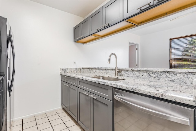 3781 59th Ave W Unit 3781, Bradenton, FL 34210 - kitchen with stainless steel dishwasher, gray cabinets, light tile patterned flooring, light stone counters, and black fridge