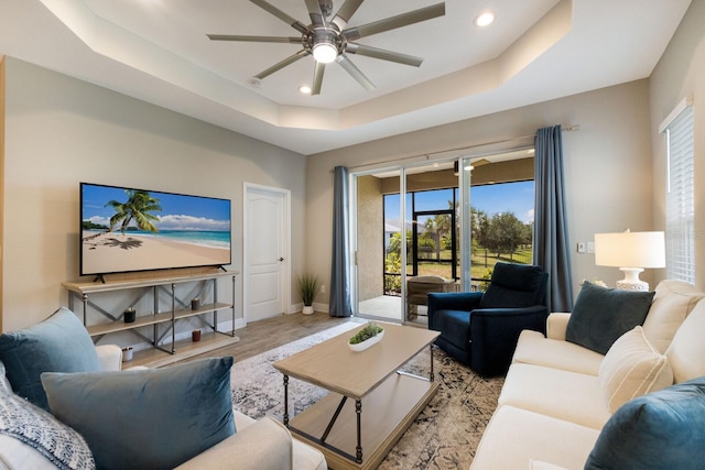 4815 Deep Creek Ter, Parrish, FL 34219 - living room featuring a raised ceiling, plenty of natural light, ceiling fan, baseboards, and recessed lighting