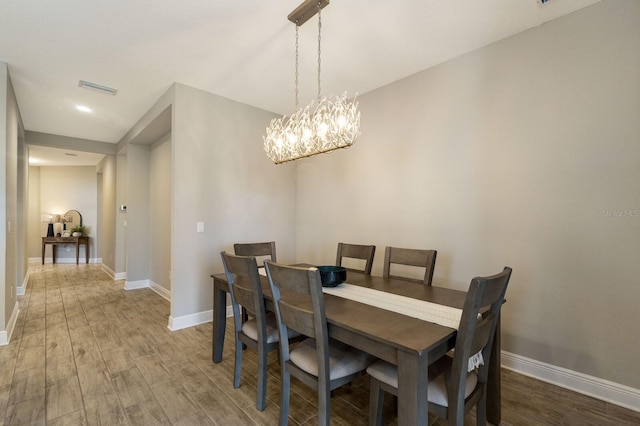 4815 Deep Creek Ter, Parrish, FL 34219 - dining room featuring wood finished floors, baseboards, and a chandelier