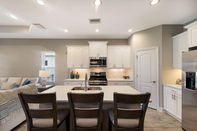 4815 Deep Creek Ter, Parrish, FL 34219 - kitchen with appliances with stainless steel finishes, a sink, light countertops, a center island with sink, and recessed lighting