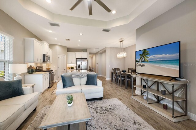 4815 Deep Creek Ter, Parrish, FL 34219 - living area featuring ceiling fan, light wood-type flooring, a chandelier, baseboards, and recessed lighting