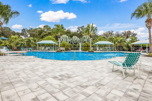 4815 Deep Creek Ter, Parrish, FL 34219 - community pool with a patio area, view of scattered trees, and a gazebo
