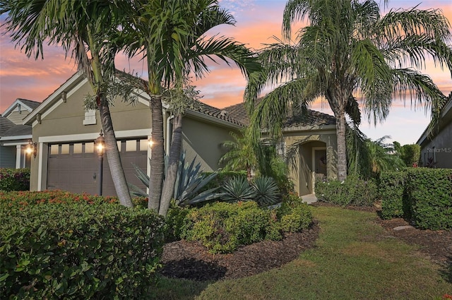 view of front of property with stucco siding and an attached garage