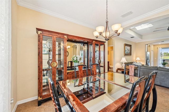 dining room featuring a chandelier, light tile patterned floors, crown molding, and baseboards