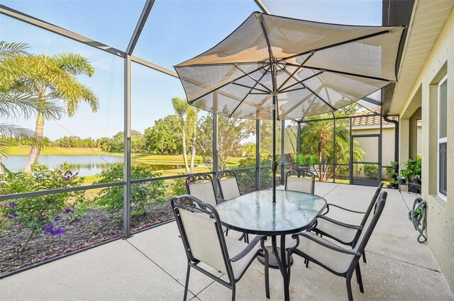 sunroom featuring a water view and outdoor dining area