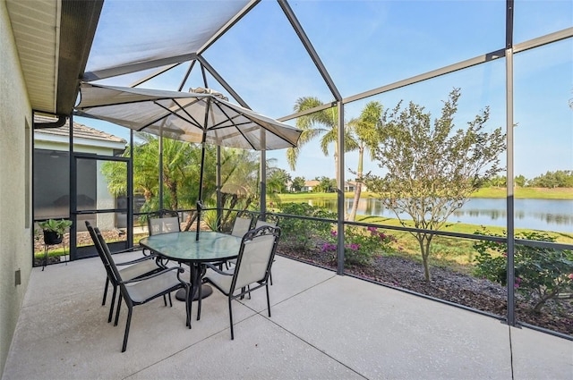 sunroom / solarium with a water view and outdoor dining area