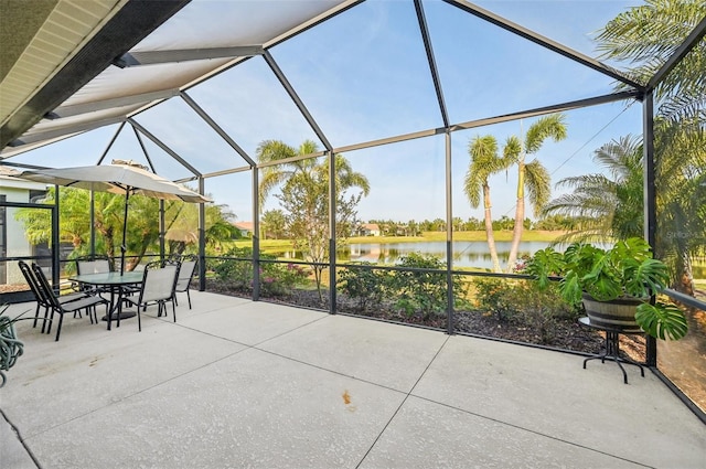 view of patio / terrace featuring a water view, a lanai, and outdoor dining area