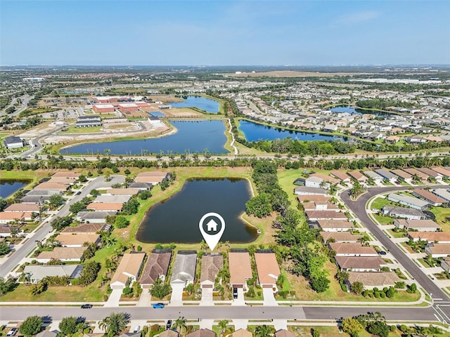 view of property location with a large body of water and nearby suburban area