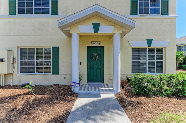 view of exterior entry with stucco siding