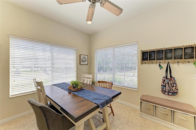 dining space featuring baseboards, ceiling fan, and light tile patterned floors