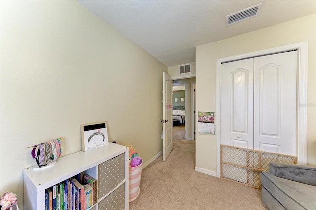 game room featuring baseboards, light colored carpet, and visible vents