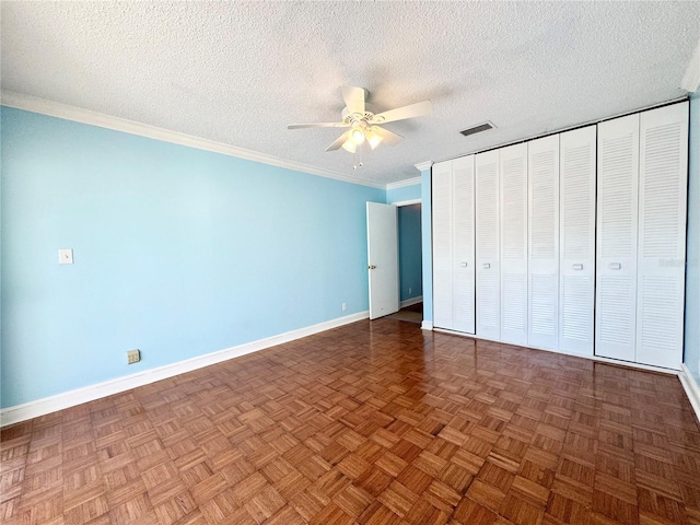 2058 Sunset Point Rd Unit 11, Clearwater, FL 33765 - unfurnished bedroom with baseboards, a textured ceiling, ornamental molding, and ceiling fan