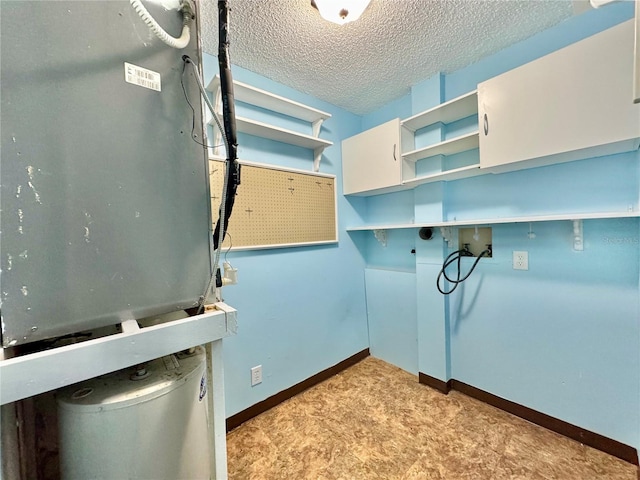 2058 Sunset Point Rd Unit 11, Clearwater, FL 33765 - laundry area with washer hookup, a textured ceiling, and baseboards
