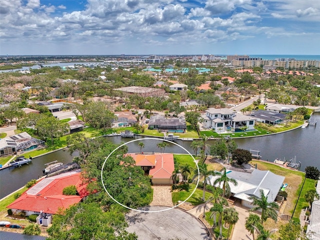 drone / aerial view with a water view and a residential view