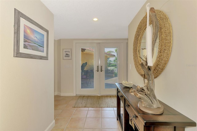 doorway featuring baseboards, french doors, light tile patterned flooring, and recessed lighting