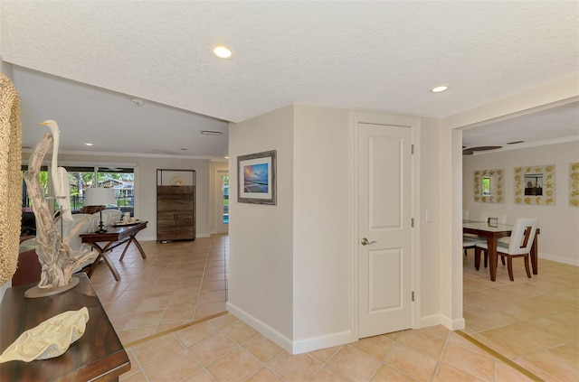 corridor featuring light tile patterned floors, baseboards, ornamental molding, and recessed lighting