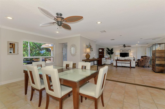 dining room with light tile patterned floors, a ceiling fan, and ornamental molding