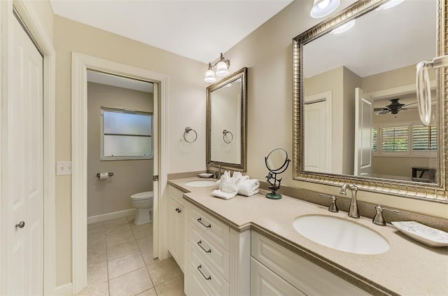 full bath with a sink, toilet, a ceiling fan, and tile patterned floors