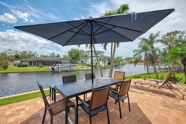 view of patio / terrace with a water view and outdoor dining space