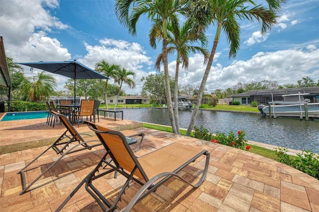 view of patio featuring a water view and outdoor dining space