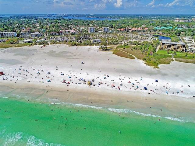bird's eye view with a water view, a view of city, and a view of the beach