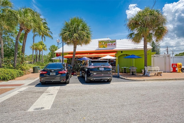 uncovered parking lot featuring fence