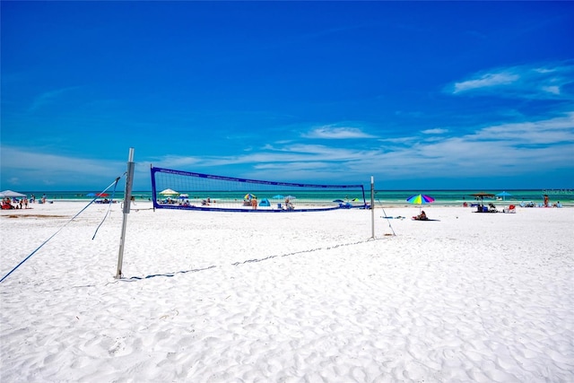 view of community with a water view and volleyball court