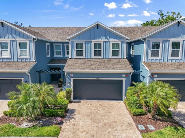 4548 Chinkapin Dr, Sarasota, FL 34232 - view of property with an attached garage, decorative driveway, and board and batten siding