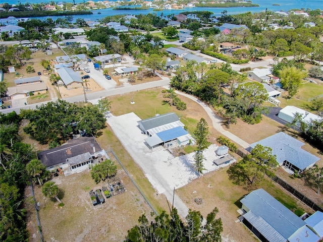birds eye view of property with a water view and a residential view
