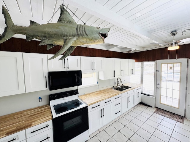 kitchen featuring wooden counters, a sink, range with electric cooktop, and black microwave