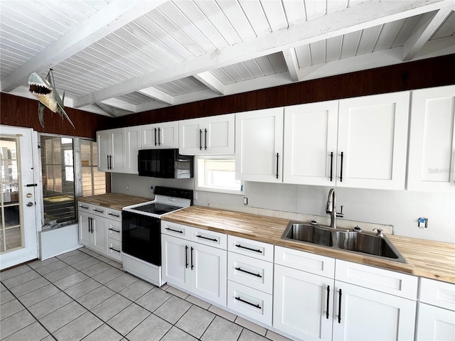 kitchen featuring wooden counters, a sink, black microwave, beam ceiling, and electric range