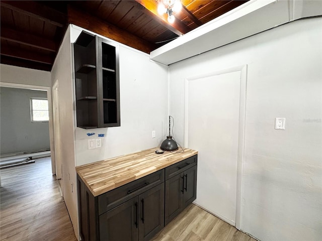 bar featuring beam ceiling, light wood-type flooring, and wooden ceiling