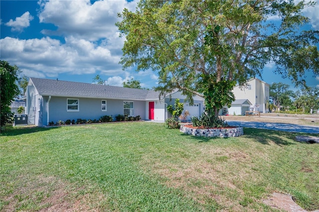ranch-style house featuring an attached garage, stucco siding, driveway, and a front yard