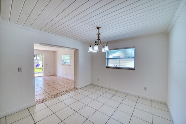 empty room with light tile patterned flooring, baseboards, a chandelier, and ornamental molding