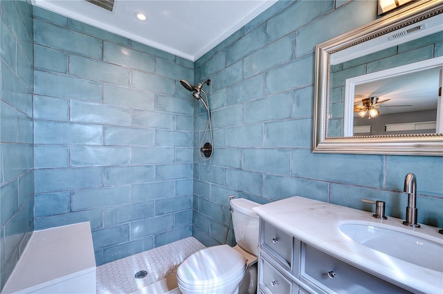 full bathroom with vanity, visible vents, toilet, tile walls, and tiled shower