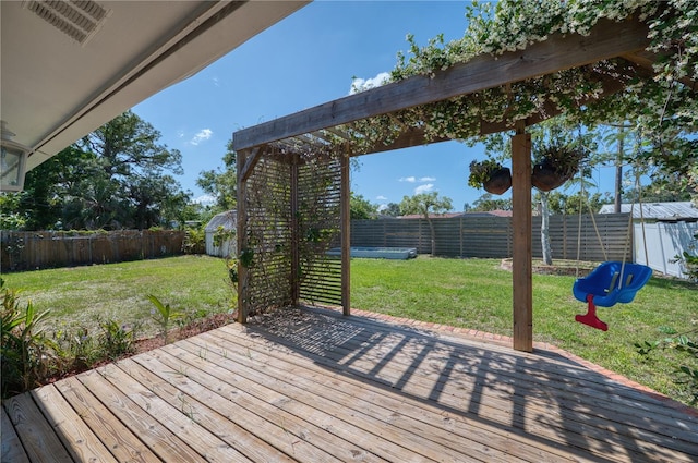 wooden deck featuring a fenced backyard and a yard