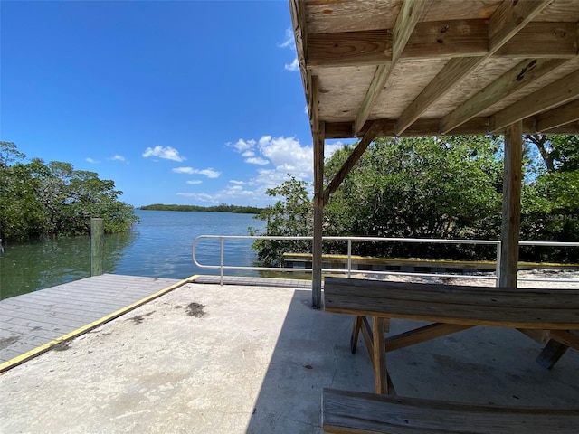 exterior space with a water view and a dock