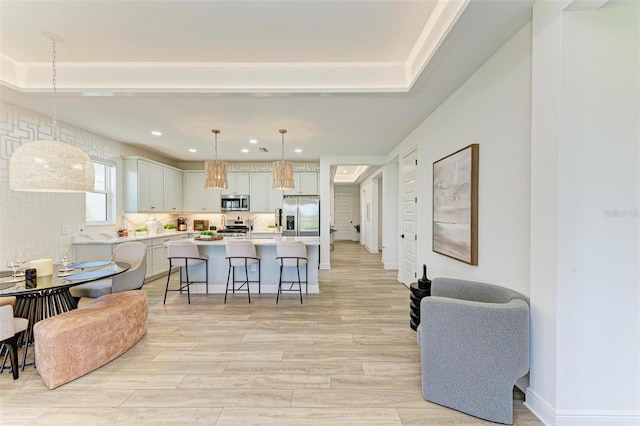 living room with light wood-style floors, recessed lighting, and baseboards