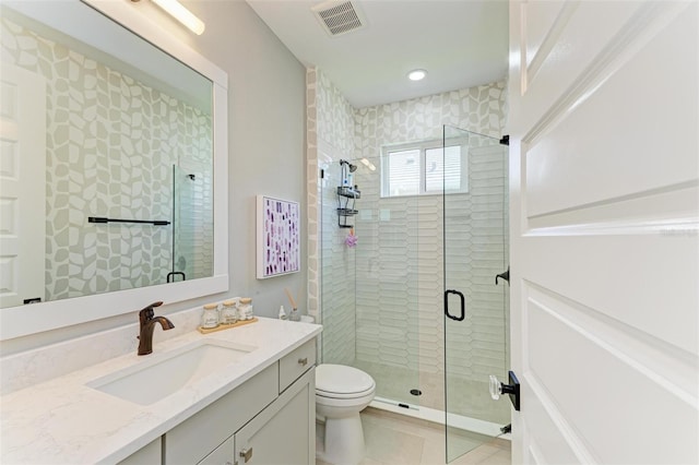 full bath featuring tile patterned flooring, vanity, toilet, visible vents, and a stall shower