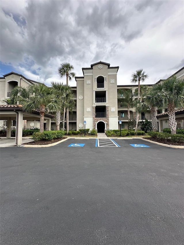 view of building exterior with uncovered parking