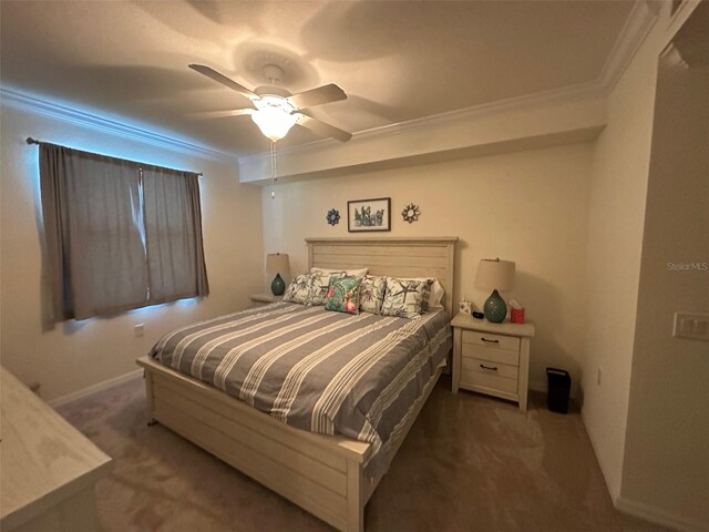 carpeted bedroom with baseboards, ornamental molding, and a ceiling fan