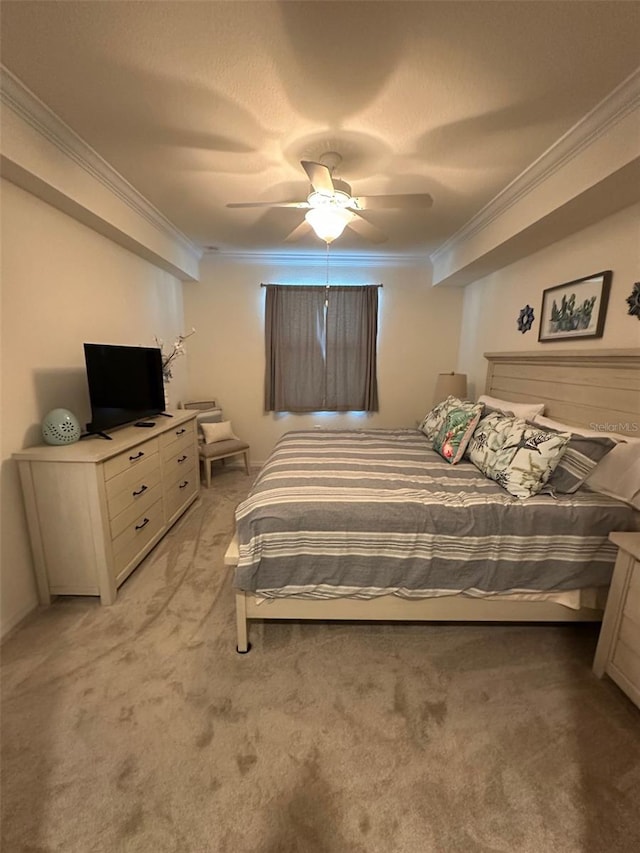 bedroom featuring ceiling fan, light colored carpet, and ornamental molding