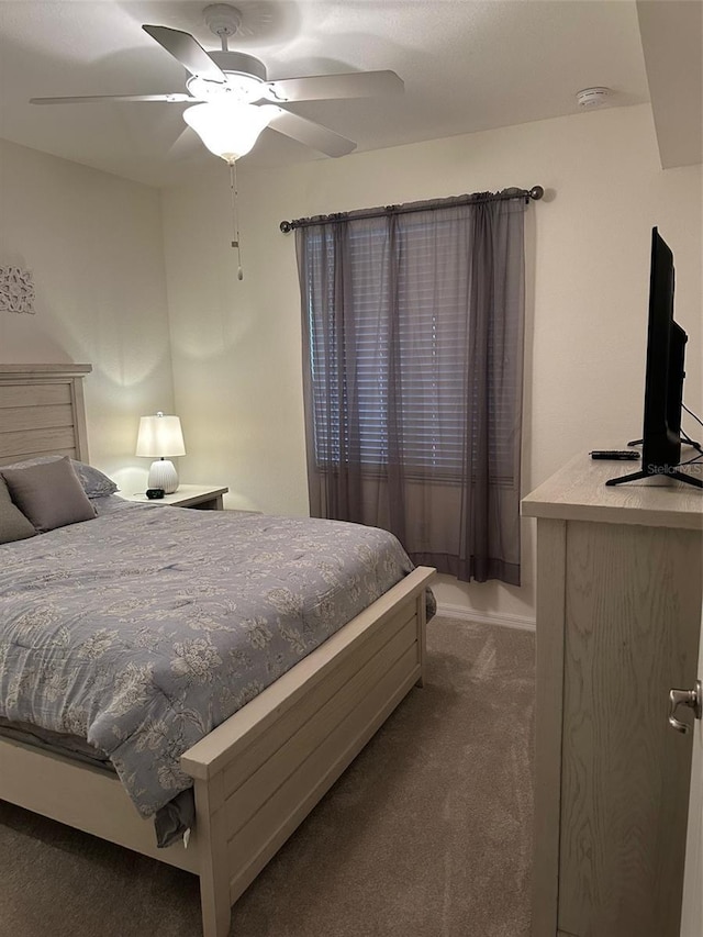 bedroom featuring ceiling fan and dark colored carpet