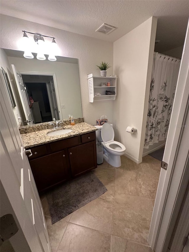 bathroom featuring visible vents, vanity, toilet, a textured ceiling, and a shower with curtain