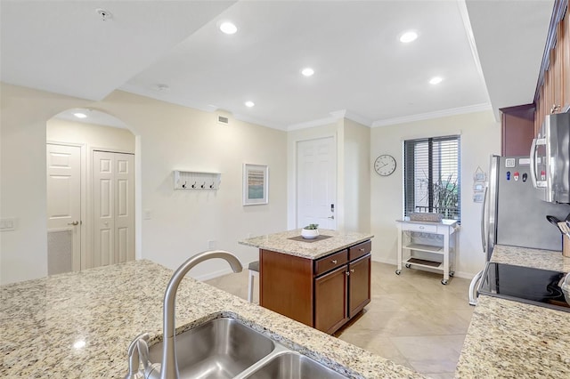 17118 Vardon Ter Unit 304, Bradenton, FL 34211 - kitchen with a sink, stainless steel appliances, crown molding, arched walkways, and baseboards