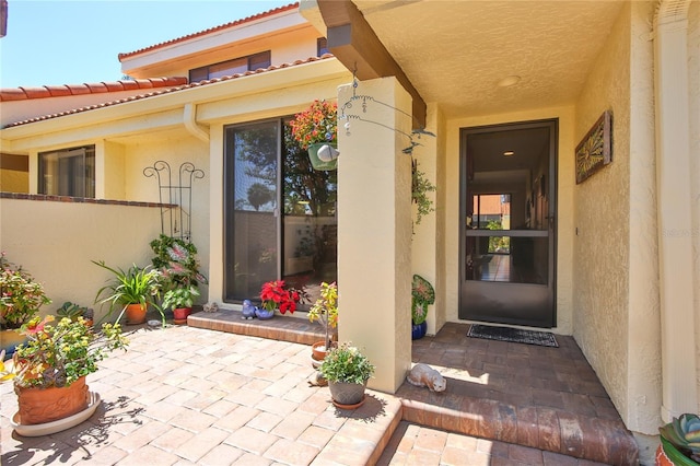5362 Huntingwood Ct Unit 16, Sarasota, FL 34235 - property entrance with stucco siding, a patio area, and a tile roof