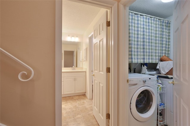 5362 Huntingwood Ct Unit 16, Sarasota, FL 34235 - clothes washing area with light tile patterned flooring, laundry area, a sink, a textured ceiling, and washer / clothes dryer